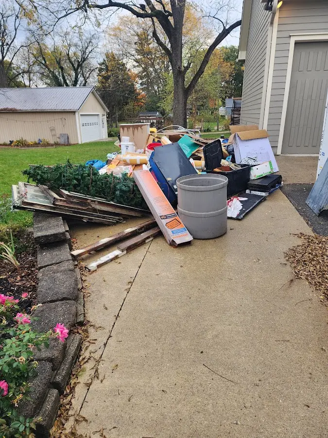 Dumpster being loaded with debris for 12 Yard Dumpster Rental in Andover